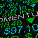 A concept image of a board with stock prices with the word "momentum" in the middle. momentum stocks to buy soon